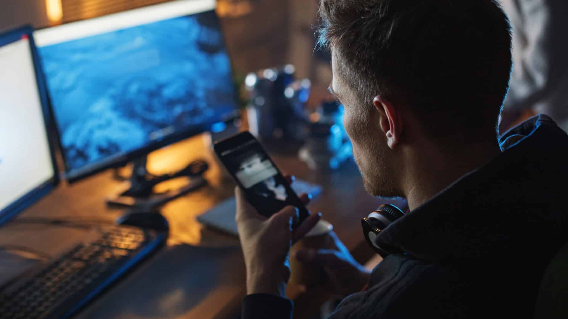 cybersecurity expert sitting infront of a computer monitoring IT environment